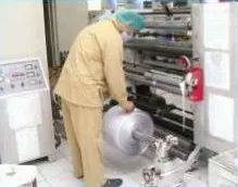 Operator rewinding a printed foil roll