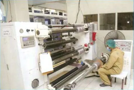 Printed foil being slit to machine width