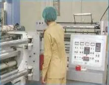Operator setting the slitting machine controls